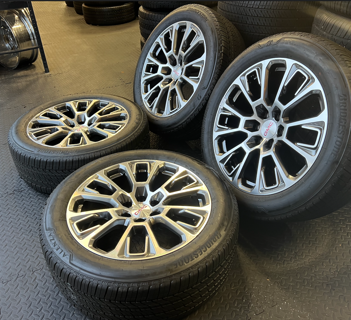 OEM 22” Machined Silver Denali Wheels wrapped in Bridgestone tires.