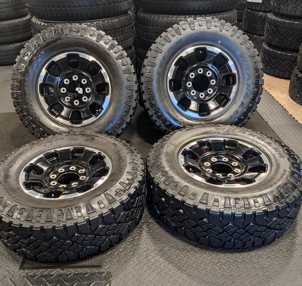 OEM 18” Gloss Black Machined Ford F-250 / F-350 Tremor Wheels wrapped in LT285/75R18 Goodyear Wrangler DuraTrac tires.