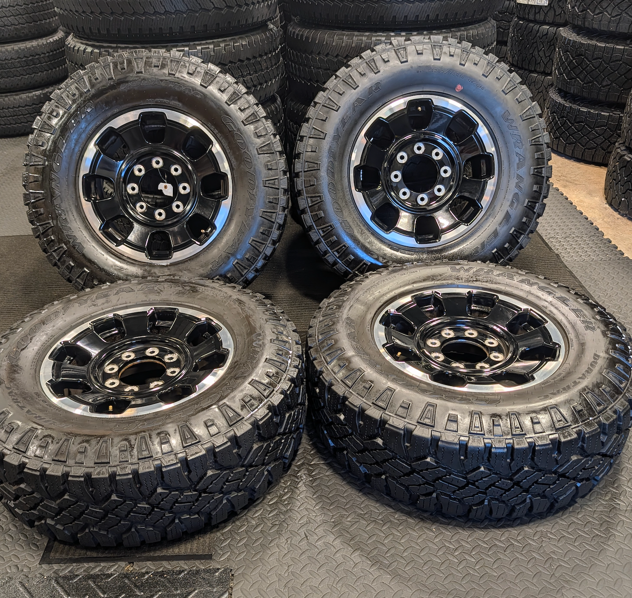 OEM 18” Gloss Black Machined Ford F-250 / F-350 Tremor Wheels wrapped in LT285/75R18 Goodyear Wrangler DuraTrac tires.