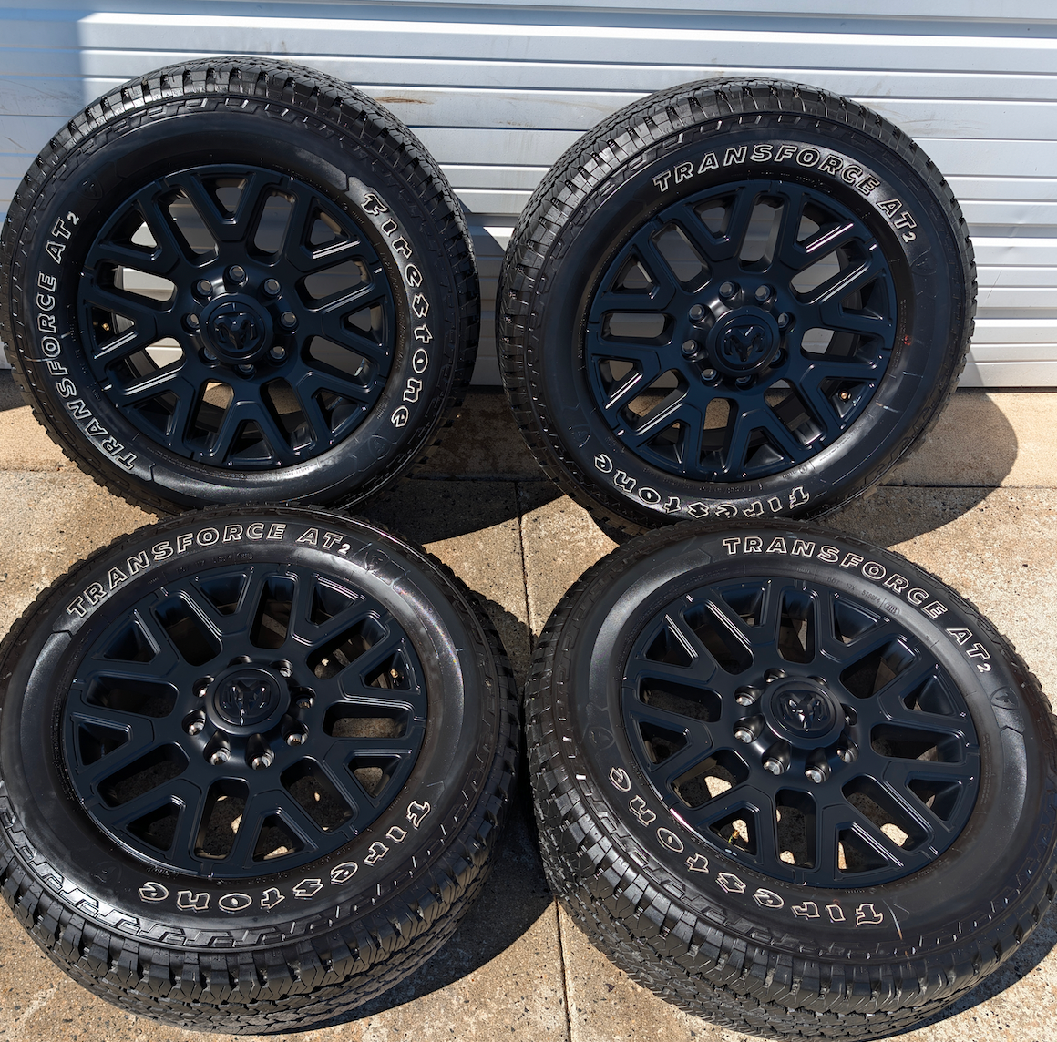 OEM 20” Matte Black Dodge RAM 2500 / 3500 Wheels wrapped in LT285/60R20 Firestone Transforce AT2 tires.