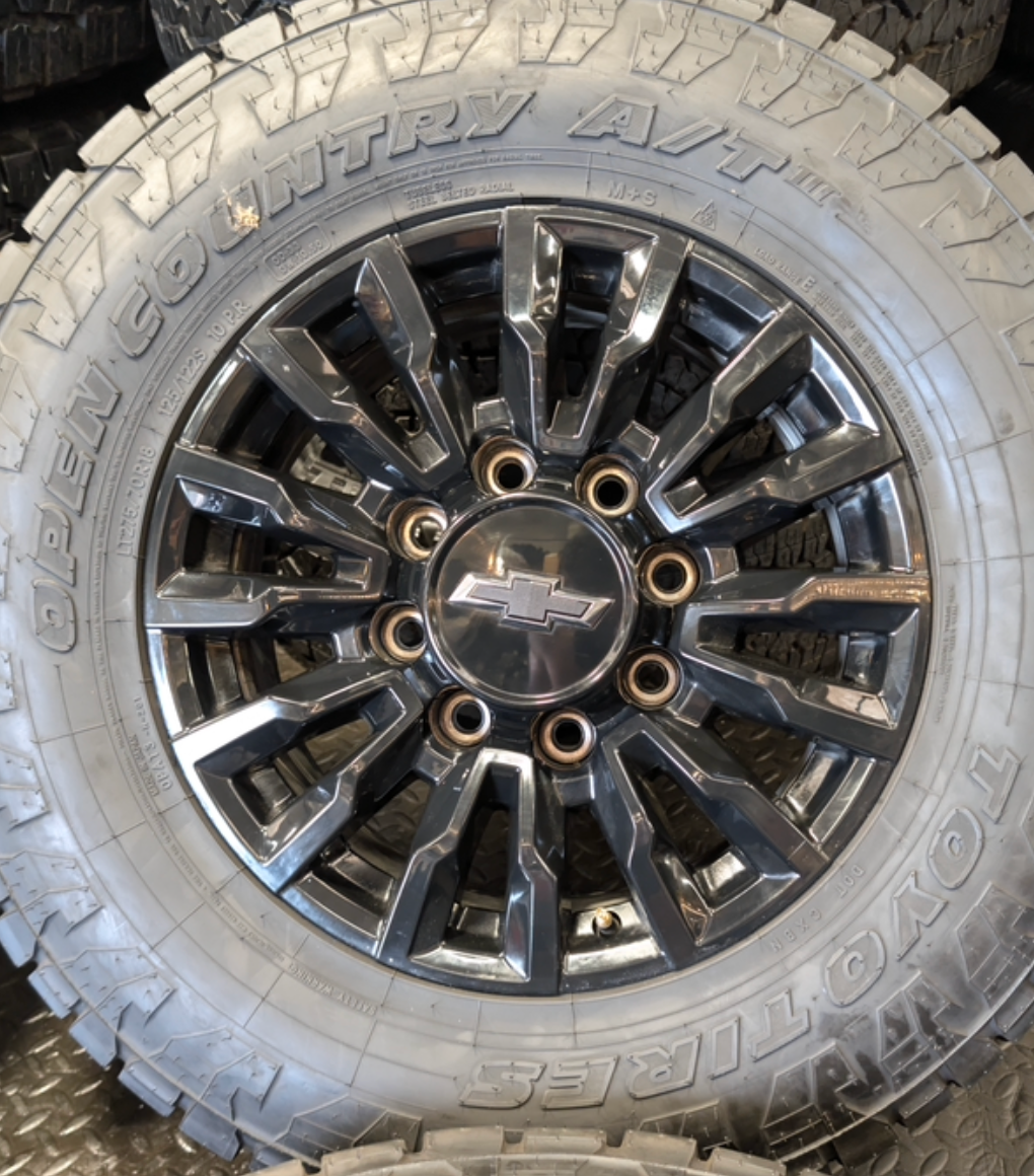 OEM 18” Chevrolet Silverado ZR2 2500HD / 3500HD Gloss Black Wheels wrapped in Toyo Open Country A/T tires.