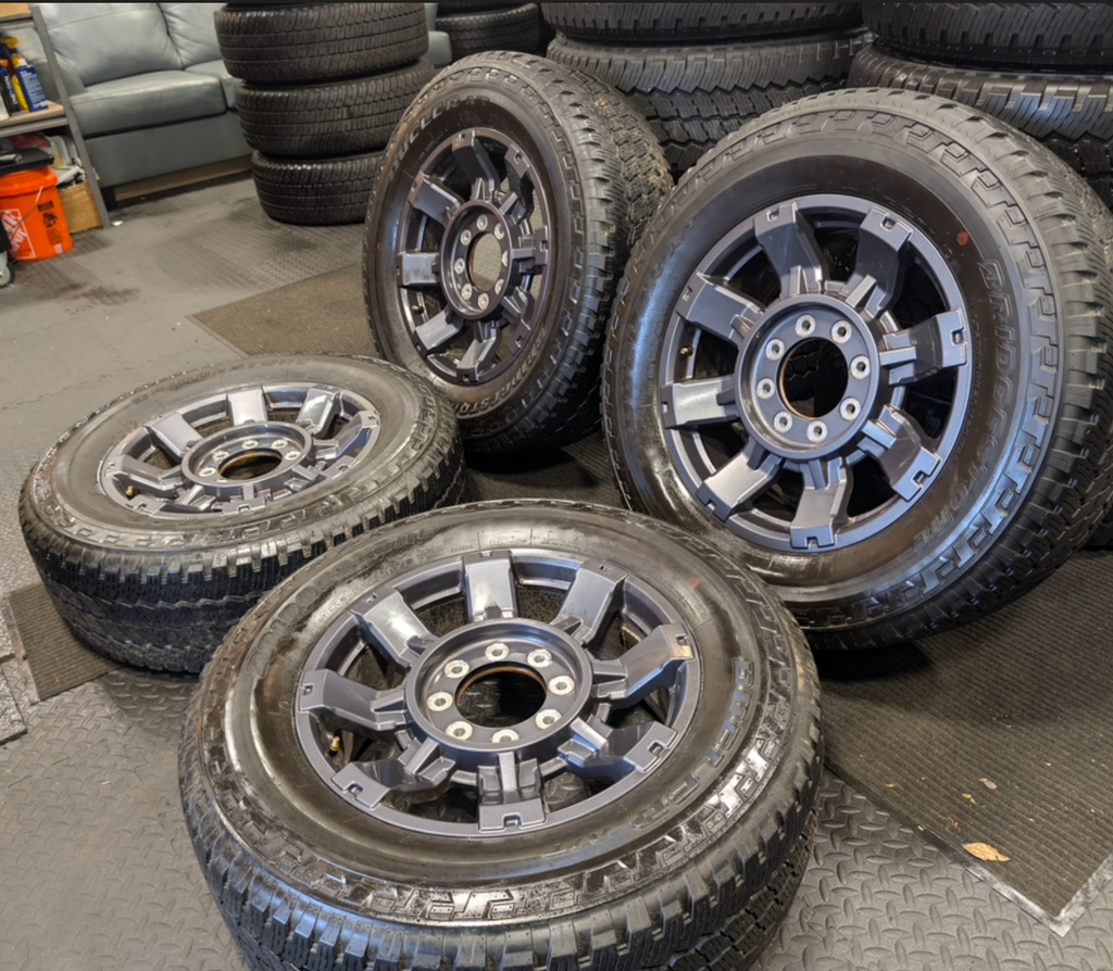 OEM 20” Dark Carbonized Gray Ford F-250 / F-350 Super Duty Wheels wrapped in Bridgestone Dueler tires.