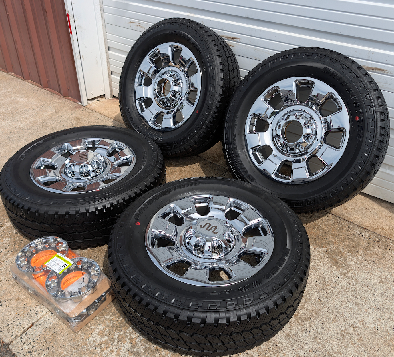 OEM 20” Chrome Ford F-250 / F-350 Wheels wrapped in Bridgestone Dueler A/T tires.