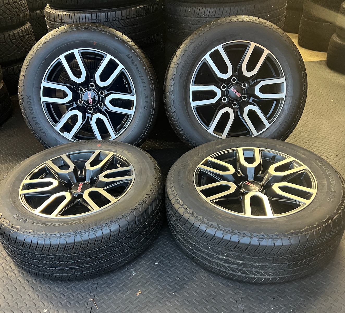 OEM 20” Gloss Black Wheels with Silver Inserts / Accents wrapped in Hankook Dynapro AT2 tires.