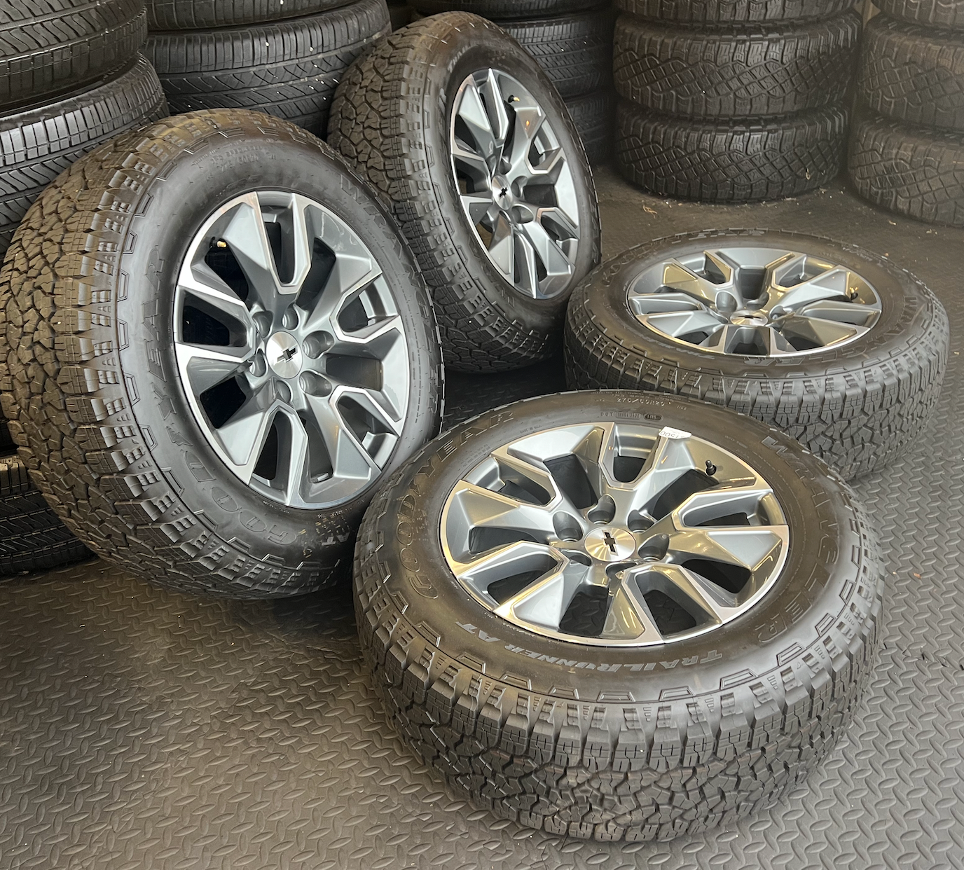 OEM 20”  Gunmetal & Machined Wheels wrapped in Goodyear Wrangler TrailRunner A/T tires.