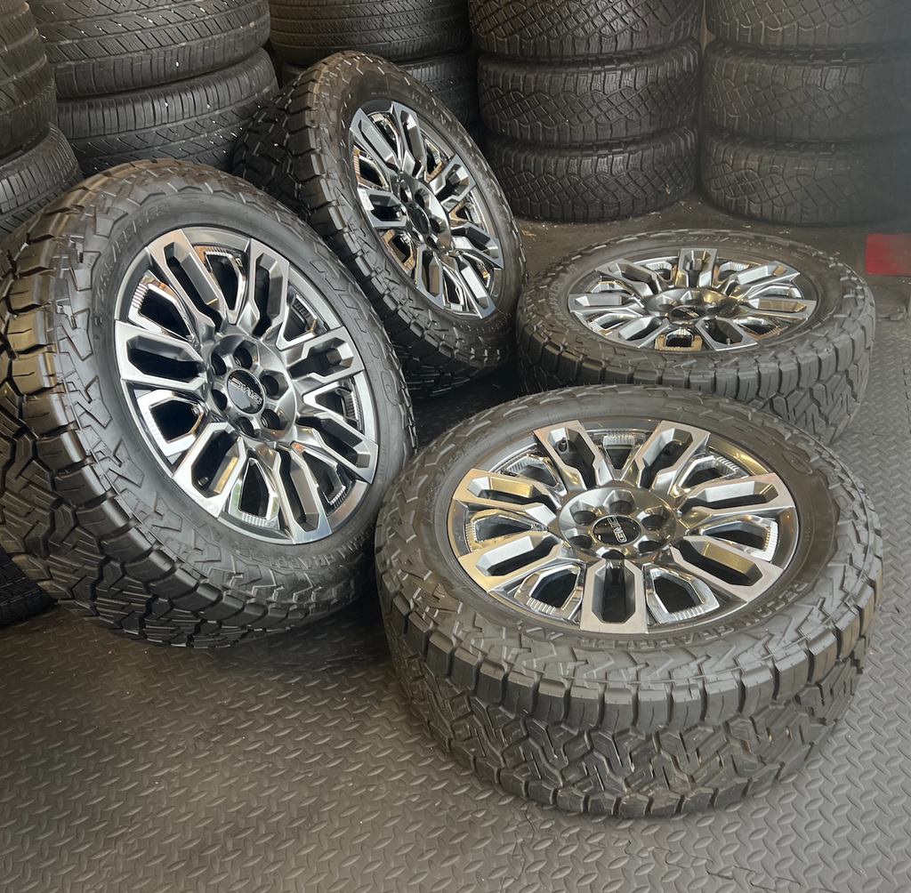 OEM 22”  Denali Ultimate Wheels with Charcoal Machined Finish & Chrome Inserts wrapped in Nitto Recon Grappler A/T tires.