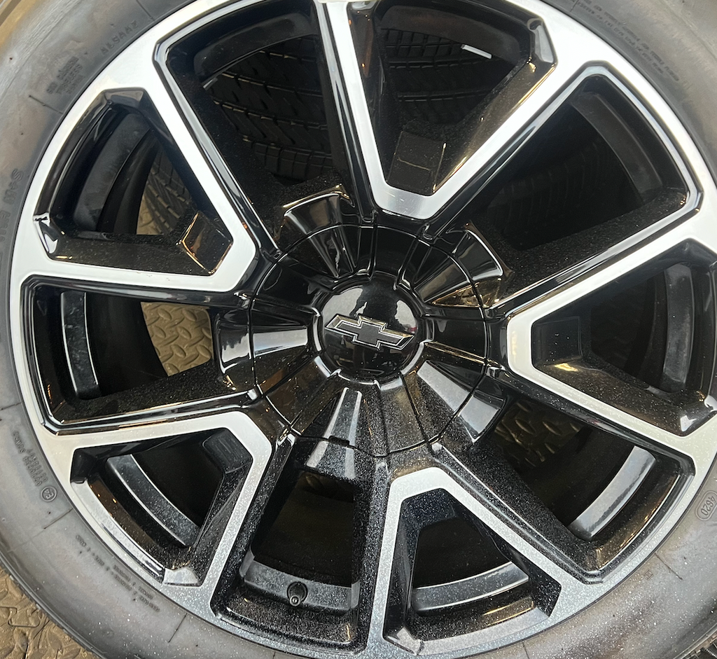 OEM 22” Black Machined Chevrolet Tahoe/Suburban Wheels wrapped in Bridgestone tires.