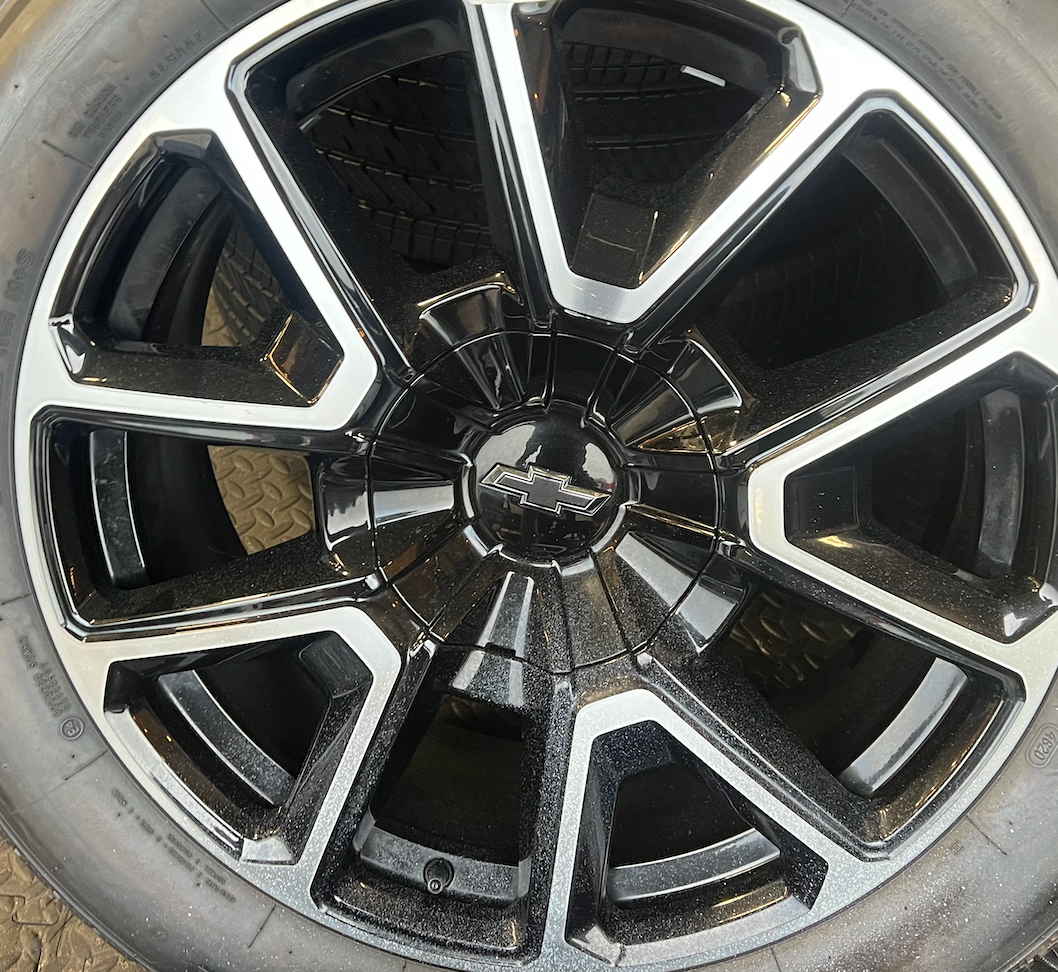 OEM 22” Black Machined Chevrolet Tahoe/Suburban Wheels wrapped in Bridgestone tires.