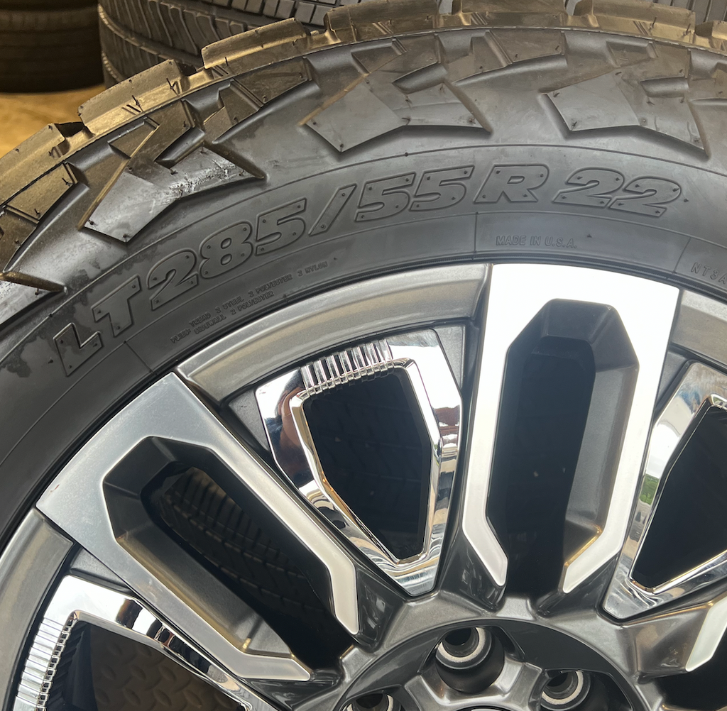 OEM 22”  Denali Ultimate Wheels with Charcoal Machined Finish & Chrome Inserts wrapped in Nitto Recon Grappler A/T tires.