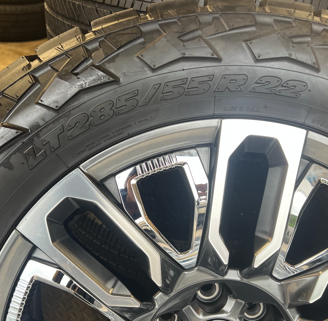 OEM 22”  Denali Ultimate Wheels with Charcoal Machined Finish & Chrome Inserts wrapped in Nitto Recon Grappler A/T tires.