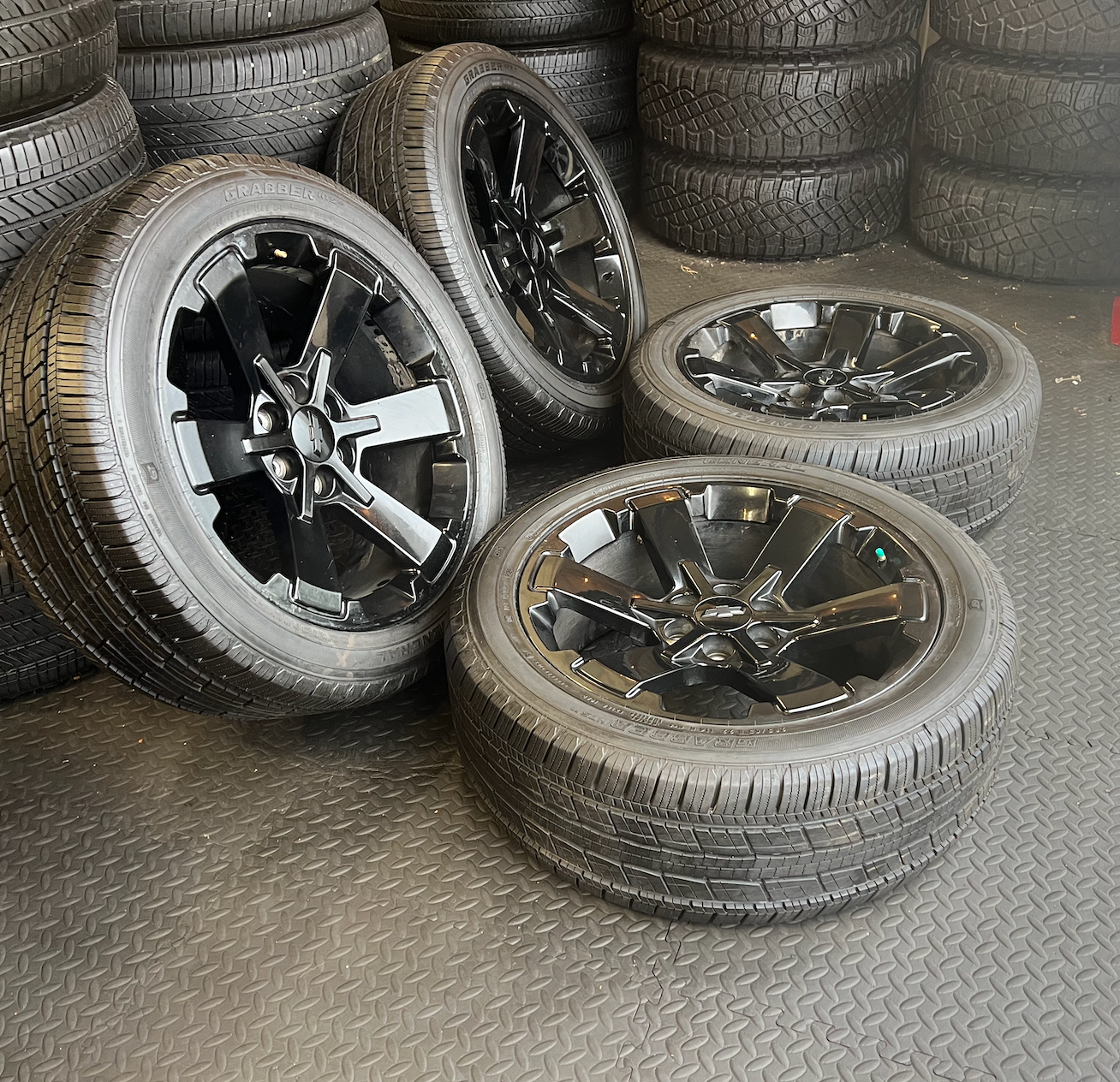 OEM 22” Gloss Black Wheels wrapped in General Grabber tires.