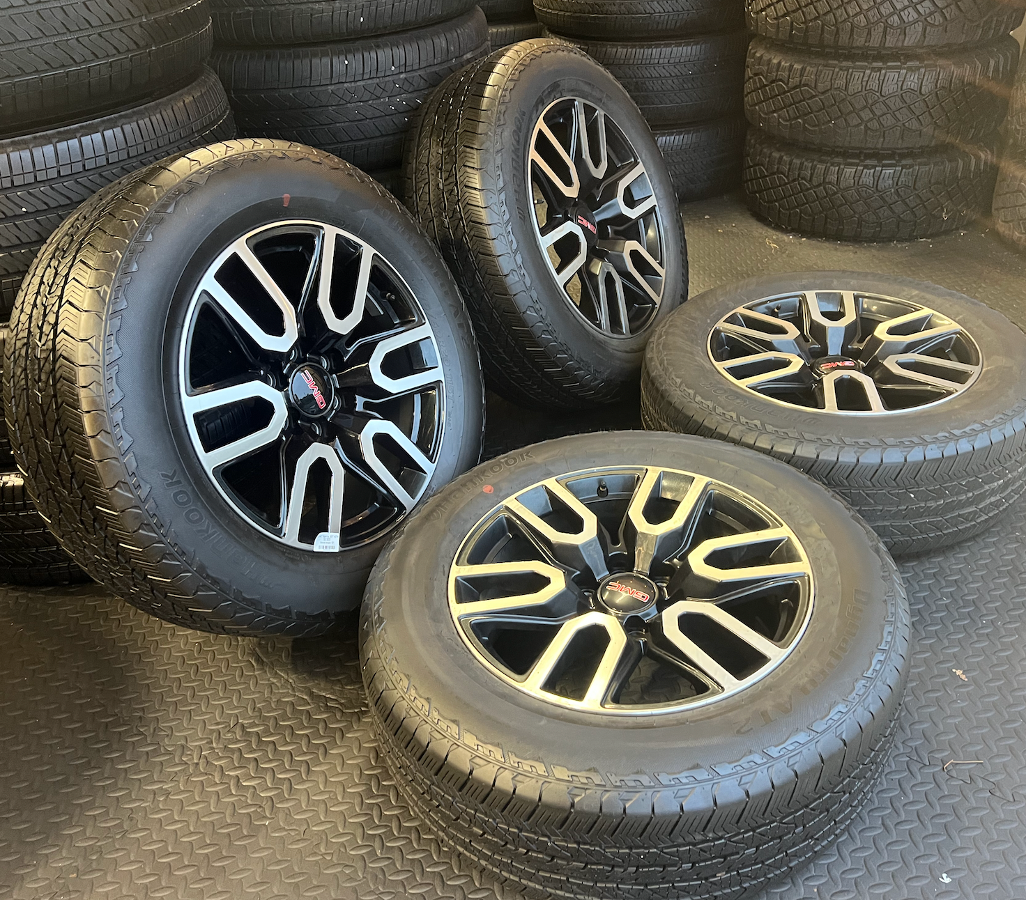 OEM 20” Gloss Black Wheels with Silver Inserts / Accents wrapped in Hankook Dynapro AT2 tires.
