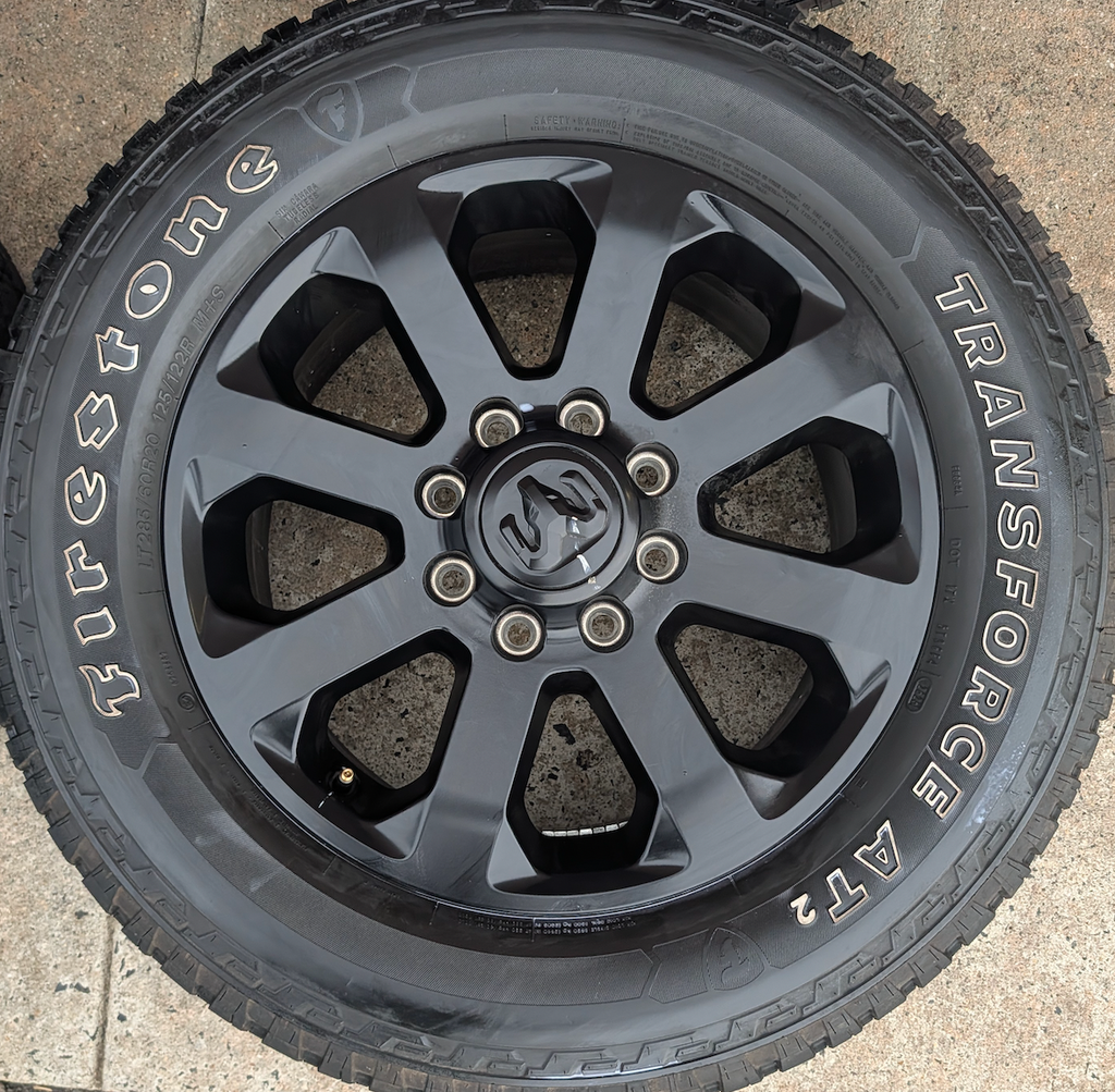 Matte Black Ram 2500 / 3500 OEM 20” Wrapped in Firestone Transforce AT2 LT285/60R20
