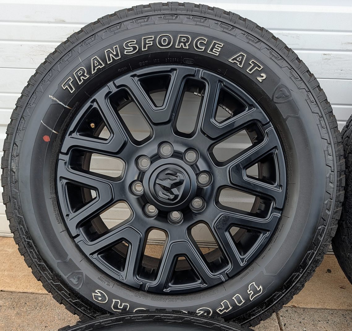 Matte Black Ram 2500 / 3500 OEM 20” Wrapped in Firestone Transforce AT2 LT285/60R20
