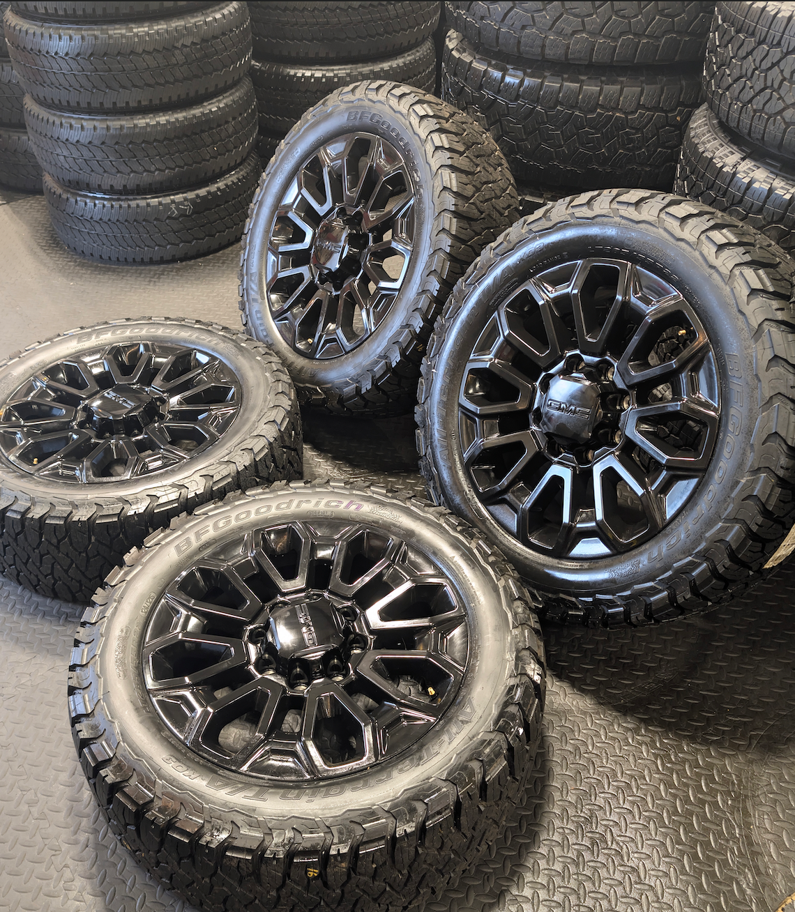 OEM 22” Gloss Black GMC Sierra 2500HD / 3500HD Wheels wrapped in BFGoodrich All-Terrain T/A KO2/KO3 tires.