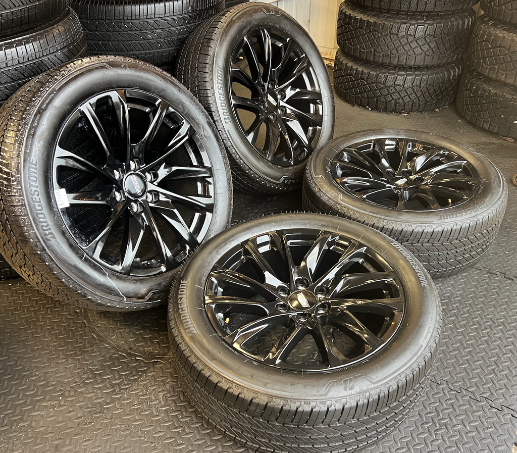 OEM 22” Gloss Black Wheels wrapped in Bridgestone tires.