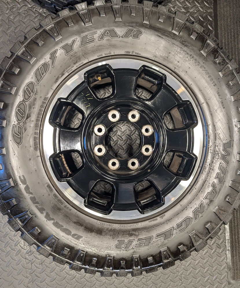 OEM 18” Gloss Black Machined Ford F-250 / F-350 Tremor Wheels wrapped in LT285/75R18 Goodyear Wrangler DuraTrac tires.