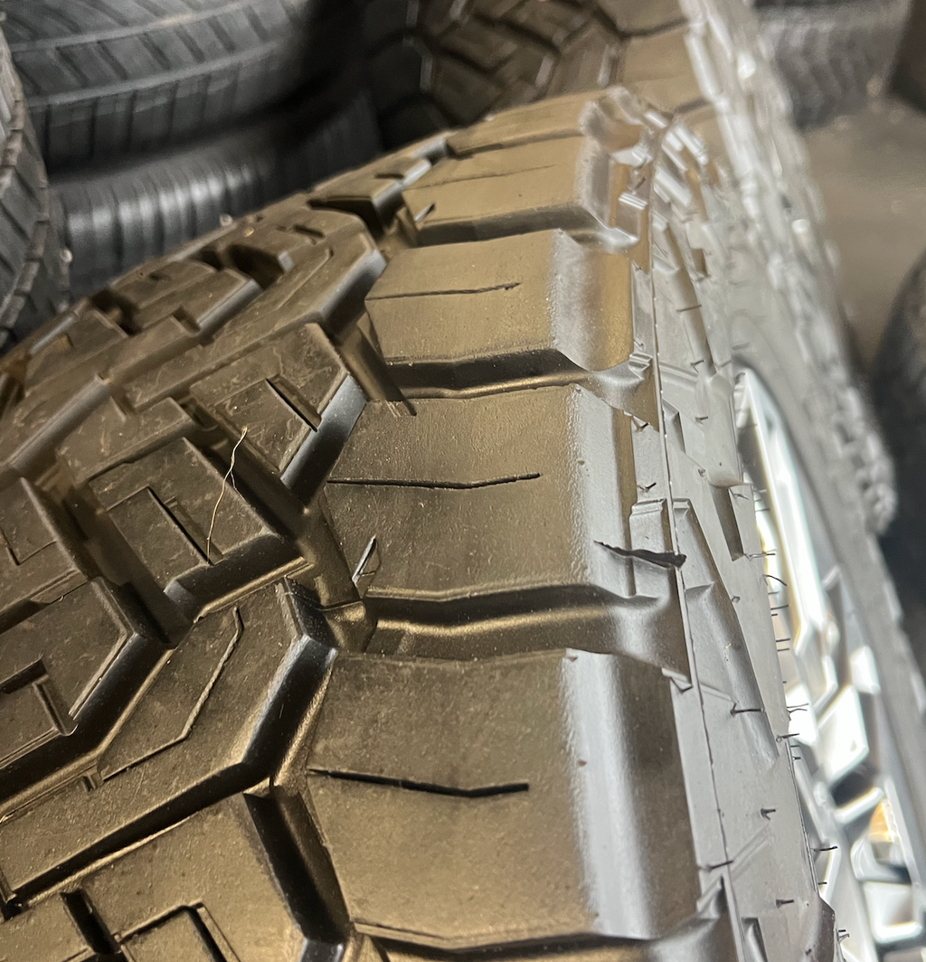 OEM 22”  Denali Ultimate Wheels with Charcoal Machined Finish & Chrome Inserts wrapped in Nitto Recon Grappler A/T tires.