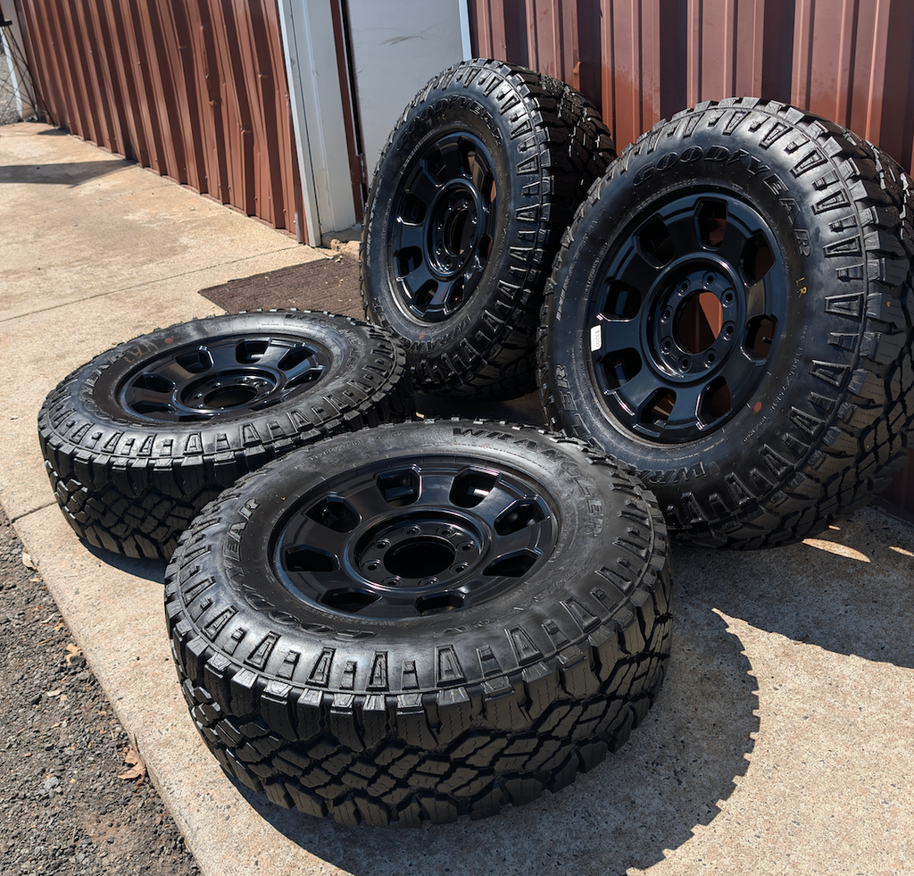 OEM 18” Ford F-250 / F-350 Tremor Wheels with Matte Black Finish wrapped in Goodyear Wrangler Duratrac tires.