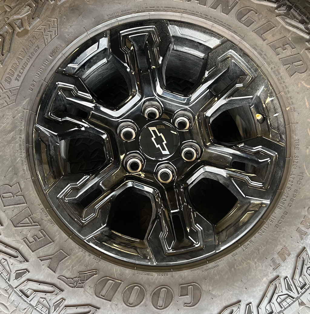 OEM 18” Gloss Black Chevrolet Silverado ZR2 Wheels wrapped in LT275/70R18 Goodyear Wrangler Territory MT tires.
