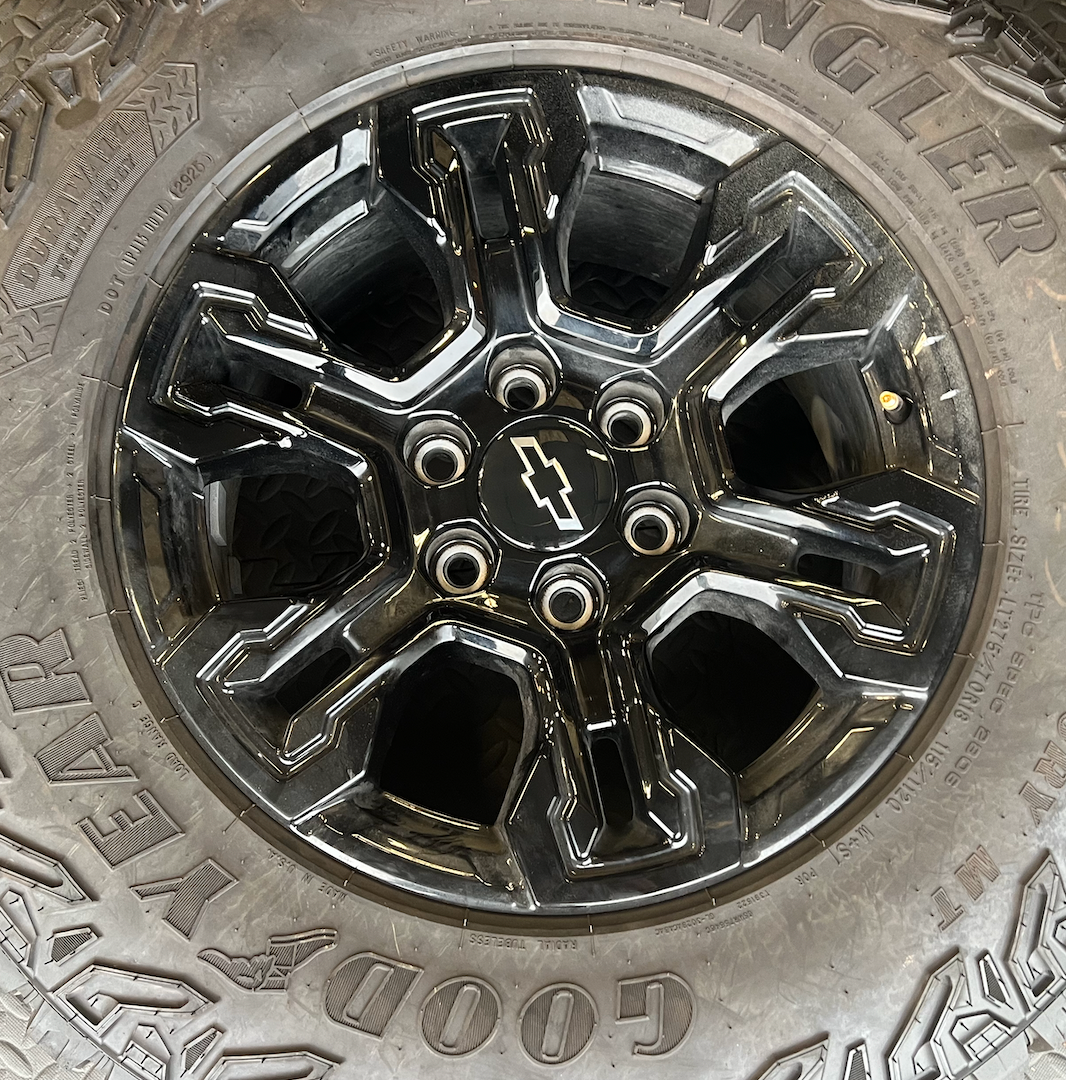 OEM 18” Gloss Black Chevrolet Silverado ZR2 Wheels wrapped in LT275/70R18 Goodyear Wrangler Territory MT tires.