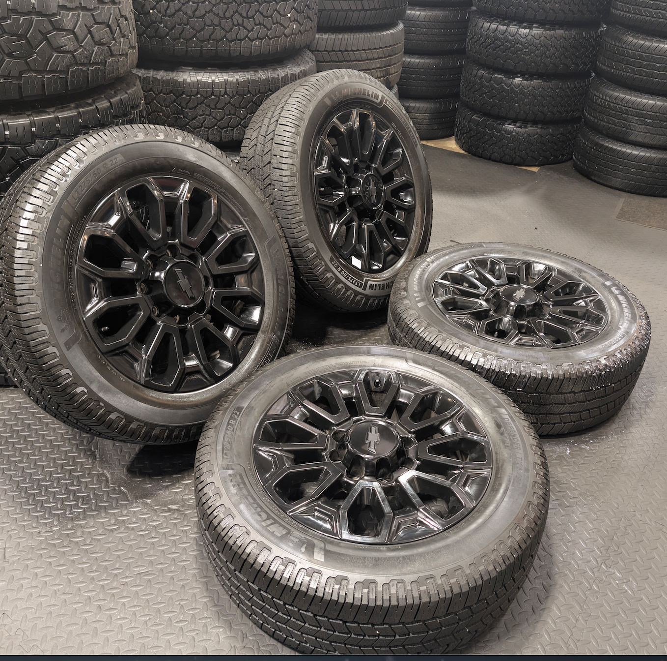 OEM 22” Gloss Black Chevrolet Silverado 2500HD / 3500HD Wheels wrapped in Michelin Defender LTX tires.