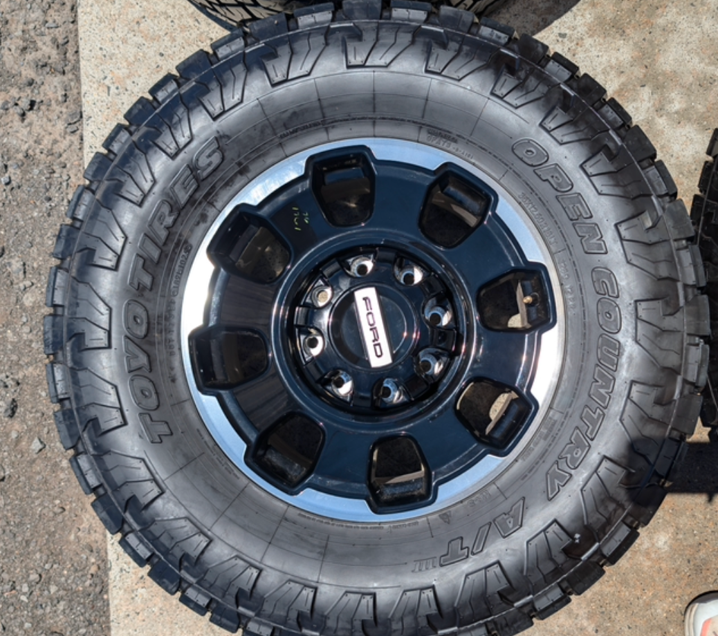 Machined Ford F-250 / F-350 Tremor OEM 18” Wrapped in Toyo Open Country A/T 35x12.50R18LT 128Q