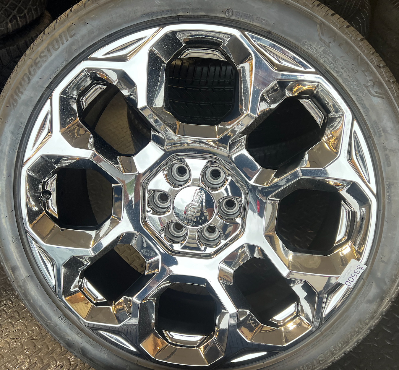 OEM 24” Chrome GMC Wheels wrapped in Bridgestone tires.