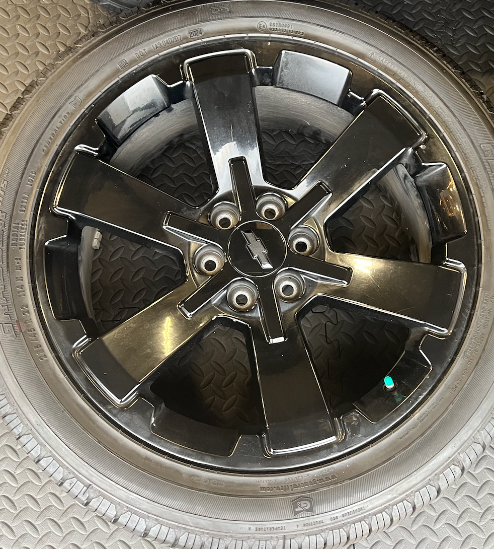 OEM 22” Gloss Black Wheels wrapped in General Grabber tires.