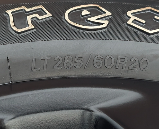 Matte Black Ram 2500 / 3500 OEM 20” Wrapped in Firestone Transforce AT2 LT285/60R20