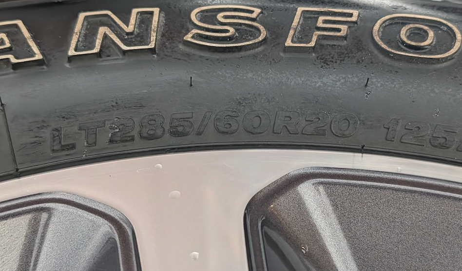 Machined 2500 / 3500 Laramie Longhorn OEM 20” Wrapped in Firestone Transforce A/T LT285/60R20