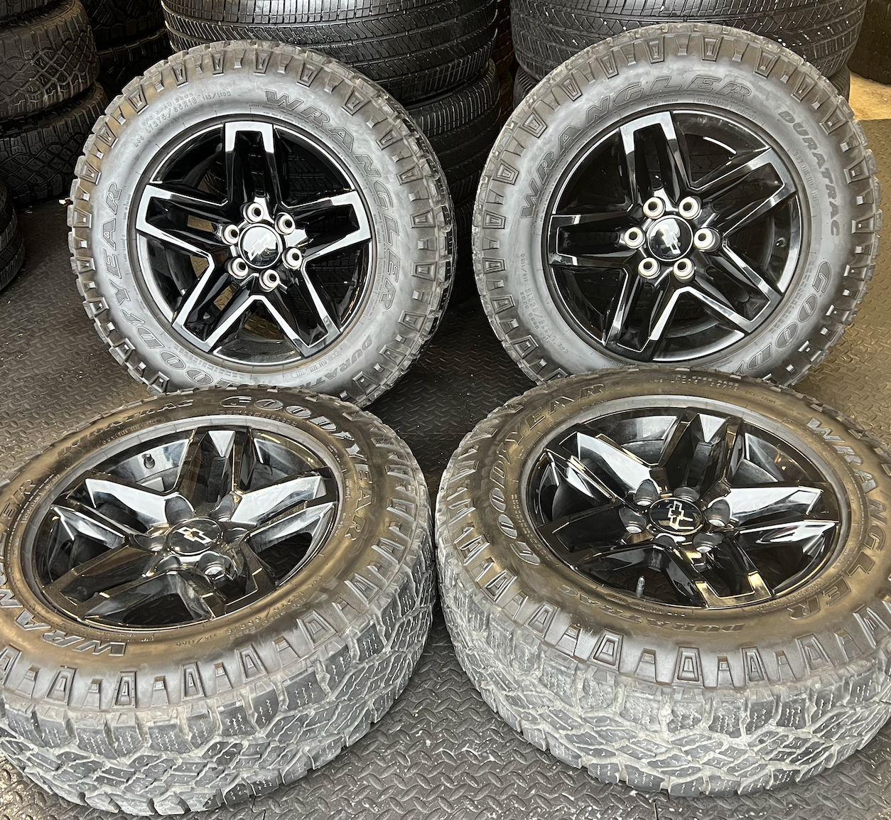 OEM 18” Gloss Black Trail Boss Wheels wrapped in Goodyear Wrangler Duratrac tires.