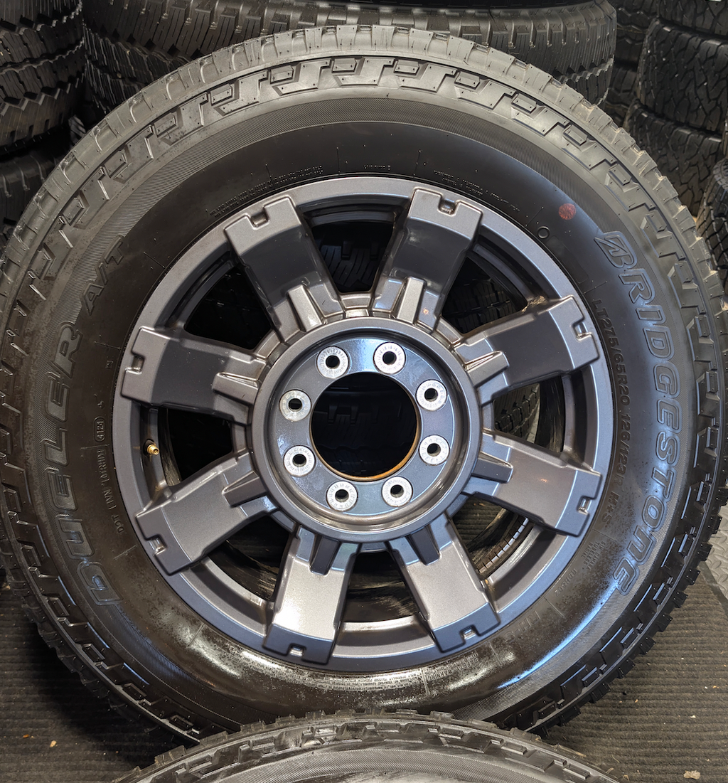 OEM 20” Dark Carbonized Gray Ford F-250 / F-350 Super Duty Wheels wrapped in Bridgestone Dueler tires.