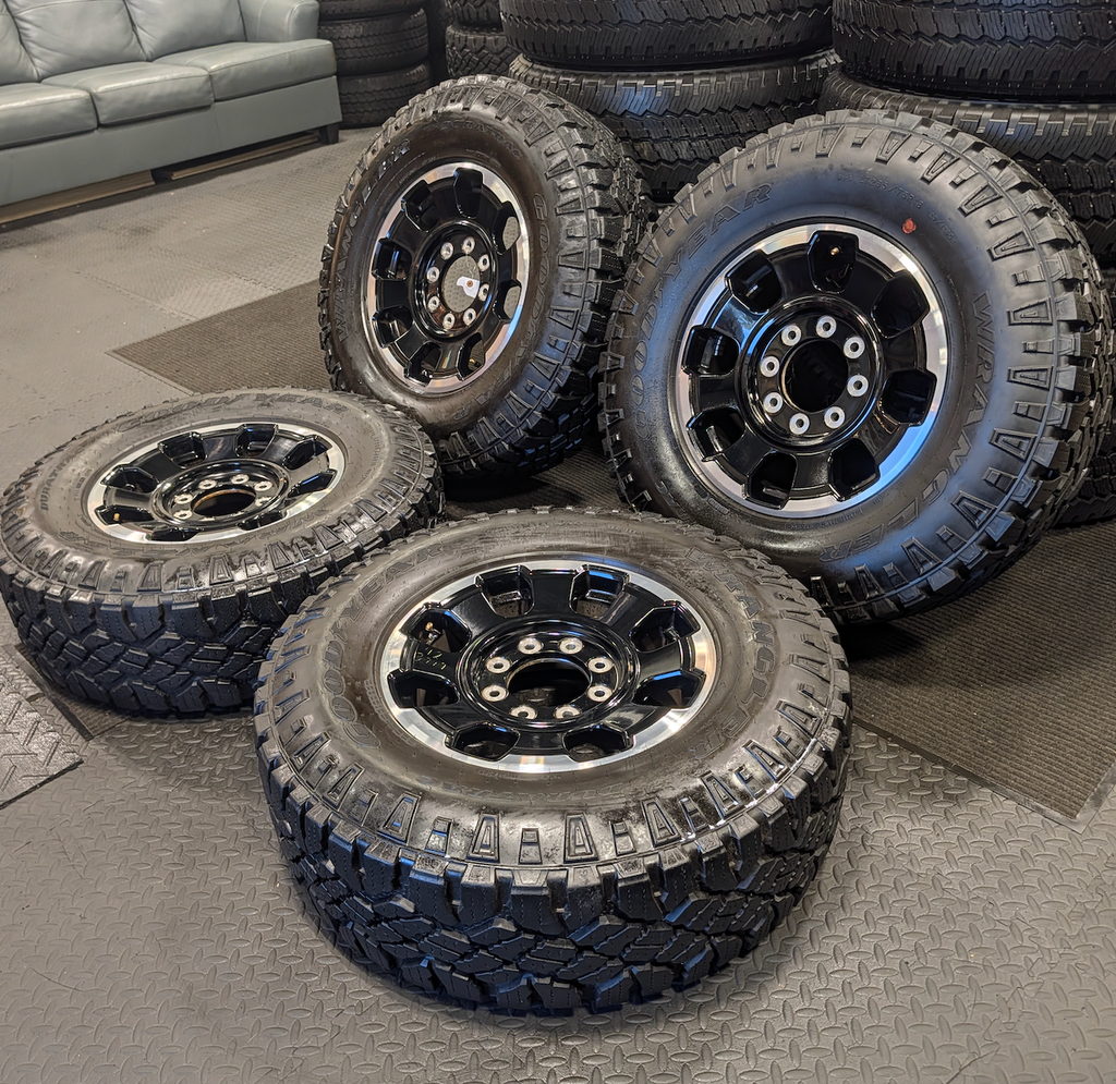 OEM 18” Gloss Black Machined Ford F-250 / F-350 Tremor Wheels wrapped in LT285/75R18 Goodyear Wrangler DuraTrac tires.