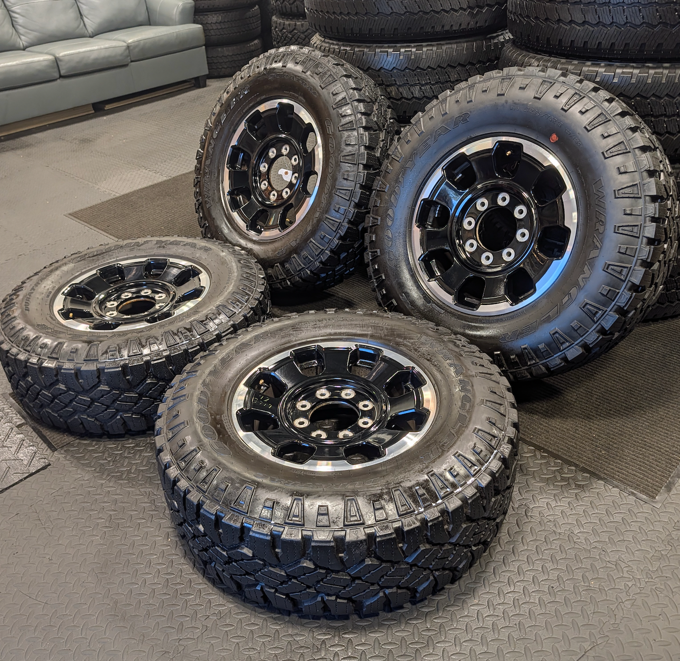 OEM 18” Gloss Black Machined Ford F-250 / F-350 Tremor Wheels wrapped in LT285/75R18 Goodyear Wrangler DuraTrac tires.