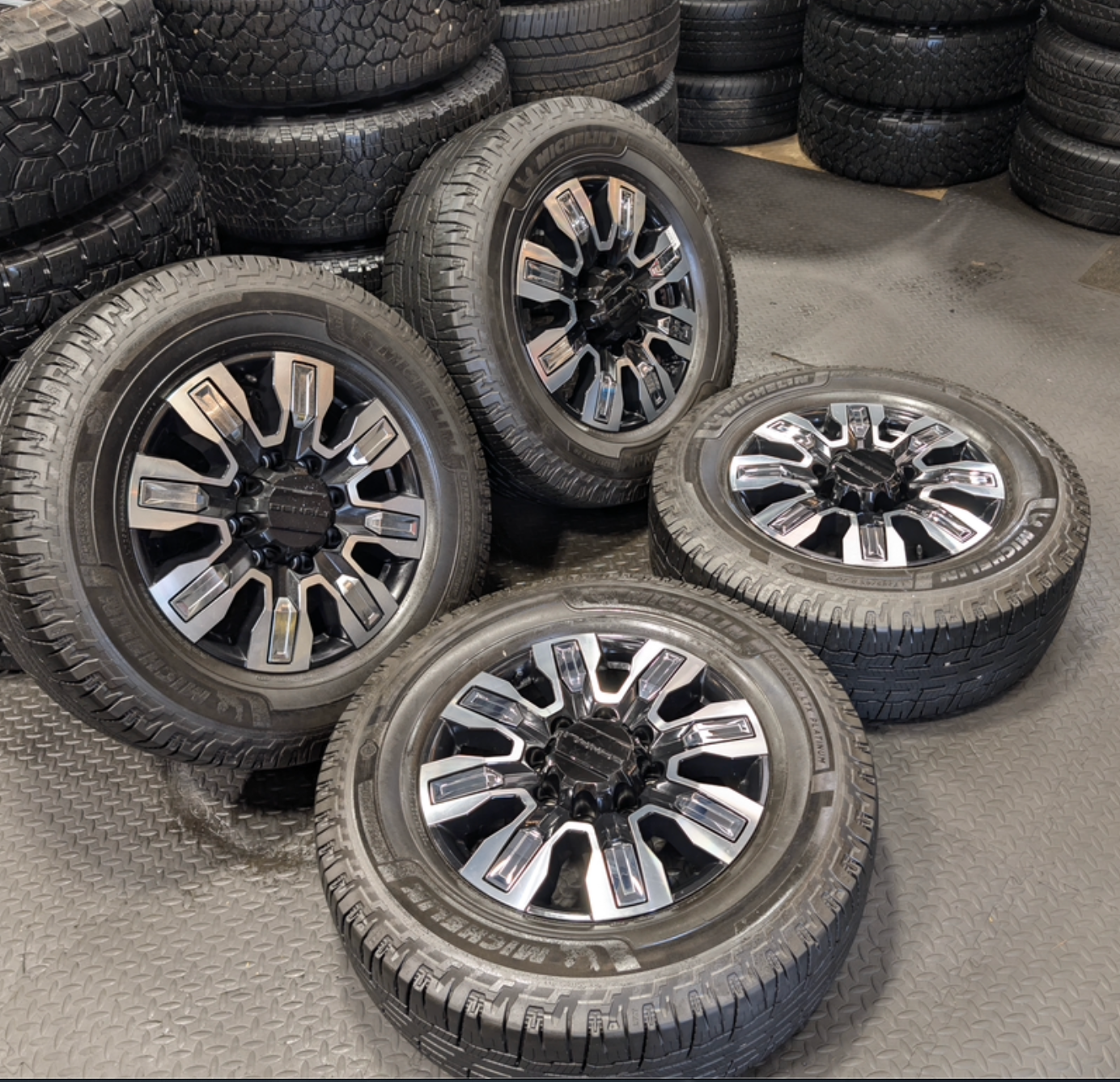 OEM 20” GMC Sierra Denali Ultimate Wheels with Machined & Black Finish wrapped in LT295/65R20 Michelin Defender LTX Platinum tires.