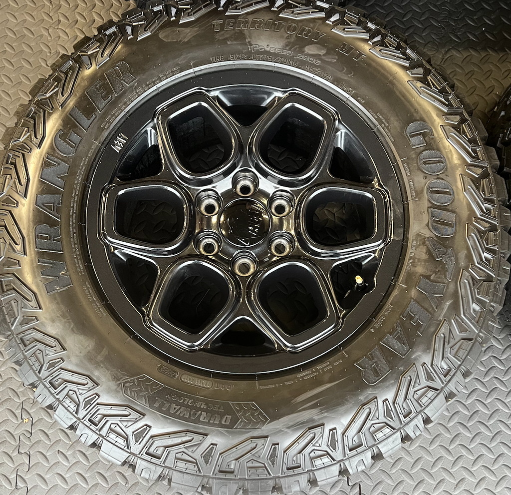 OEM 18”  Wheels wrapped in Goodyear Wrangler Territory M/T tires.
