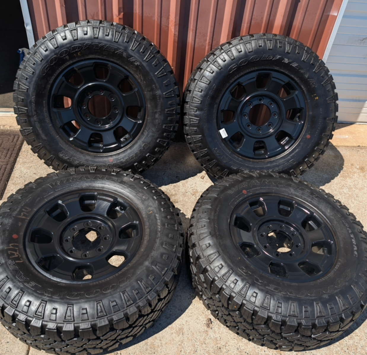 OEM 18” Ford F-250 / F-350 Tremor Wheels with Matte Black Finish wrapped in Goodyear Wrangler Duratrac tires.