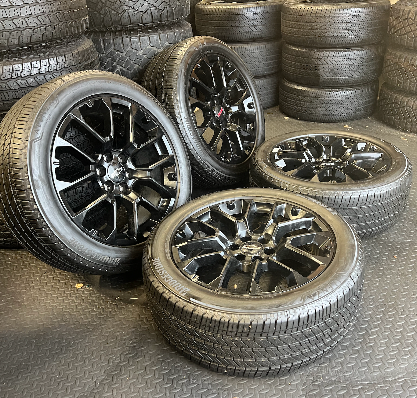 OEM 22” Gloss Black Replica Wheels wrapped in Bridgestone tires.