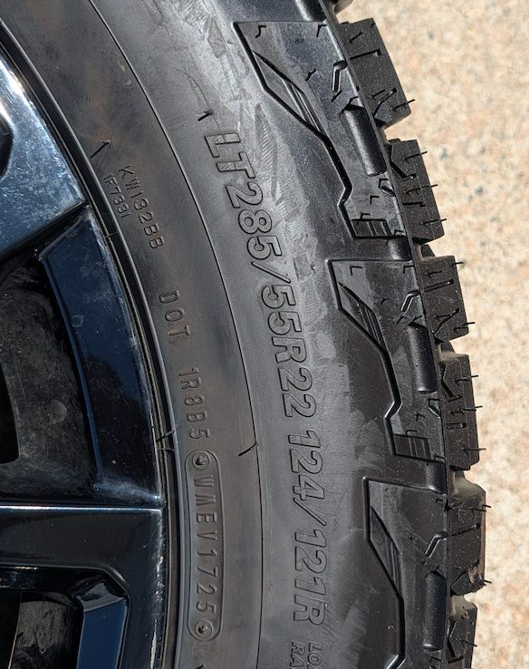 OEM 22” Gloss Black GMC HD Wheels with Split-Spoke Design wrapped in LT285/55R22 Falken Wildpeak A/T4W tires.