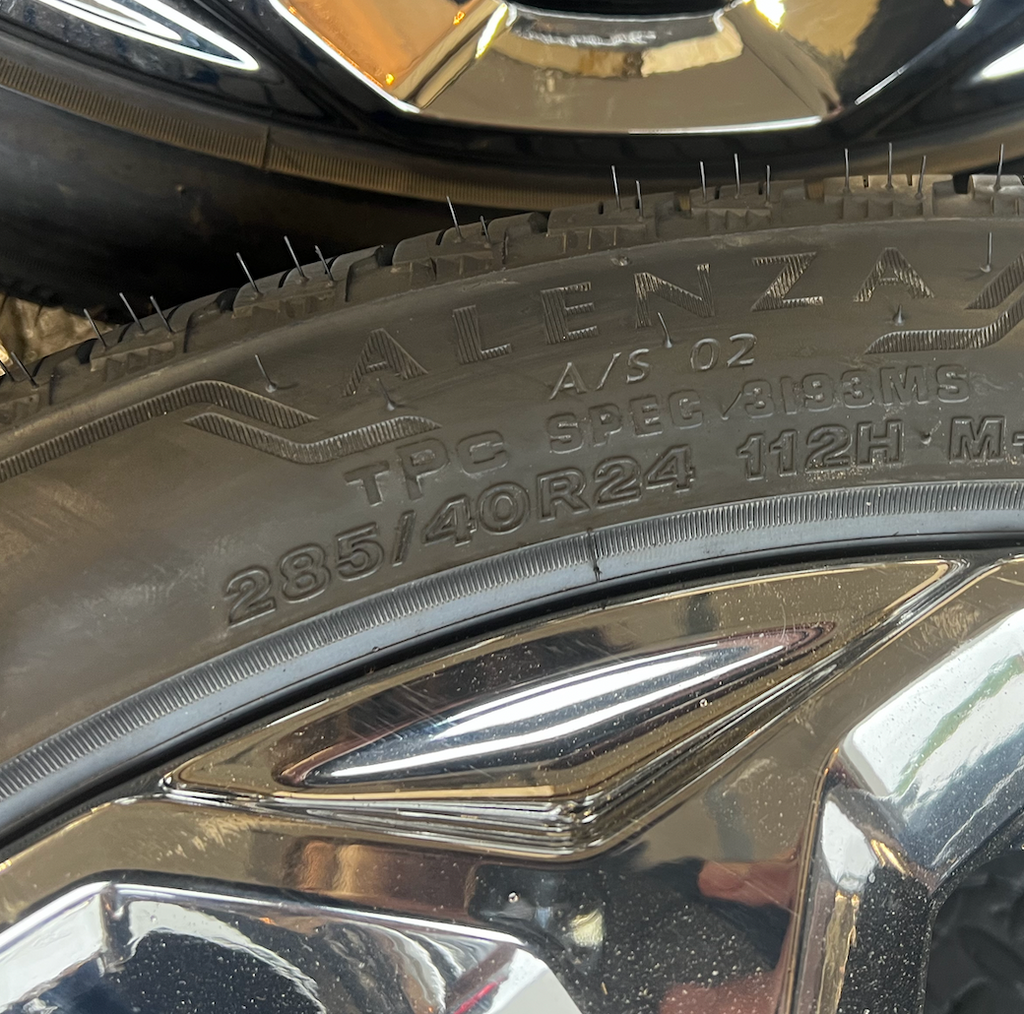 OEM 24” Chrome GMC Wheels wrapped in Bridgestone tires.