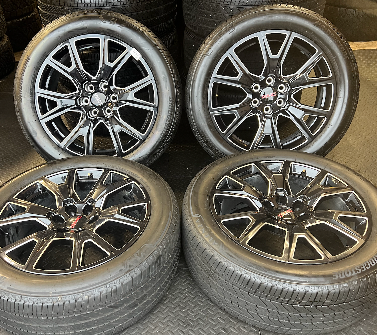 OEM 22” Gloss Black Machined Wheels wrapped in Bridgestone tires.