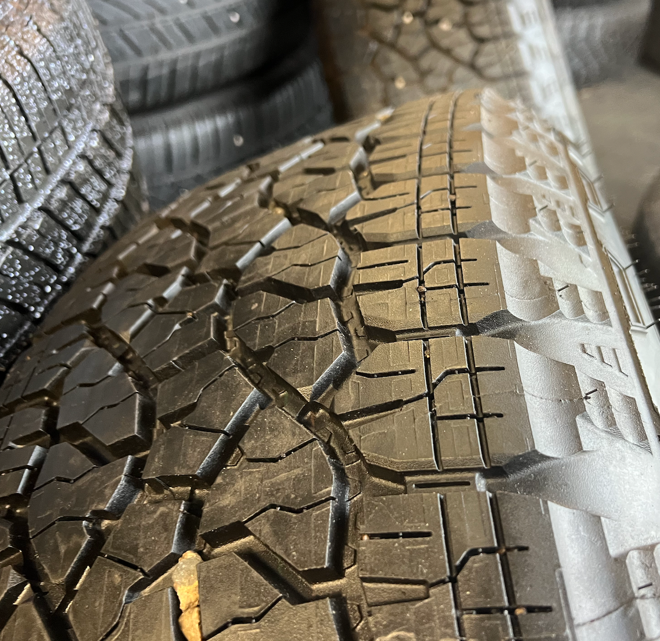 OEM 20” Gloss Black Wheels with Silver Inserts / Accents wrapped in Goodyear Wrangler TrailRunner A/T tires.