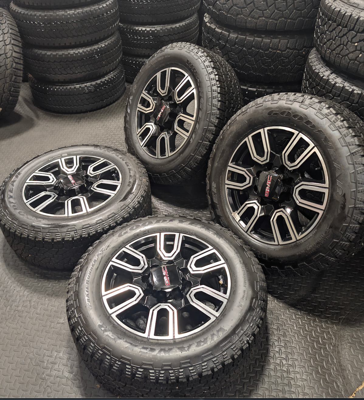 OEM 20” GMC Sierra AT4 2500HD / 3500HD Wheels with Black & Machined Finish wrapped in LT275/65R20 Goodyear Wrangler TrailRunner A/T tires.