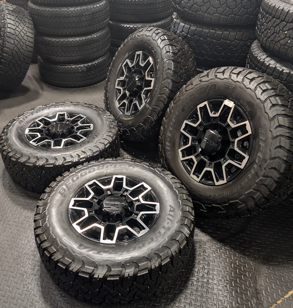 OEM 18” GMC Sierra 2500HD Wheels with Machined Black Finish wrapped in LT305/70R18 BFGoodrich All-Terrain T/A KO3 tires.