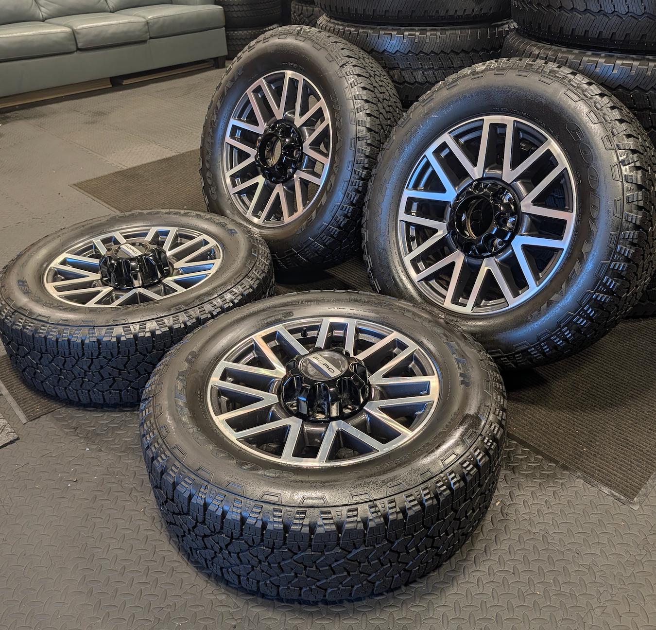 OEM 20” Machined Aluminum Ford F-250 / F-350 Super Duty Wheels wrapped in Goodyear Wrangler TrailRunner A/T tires.