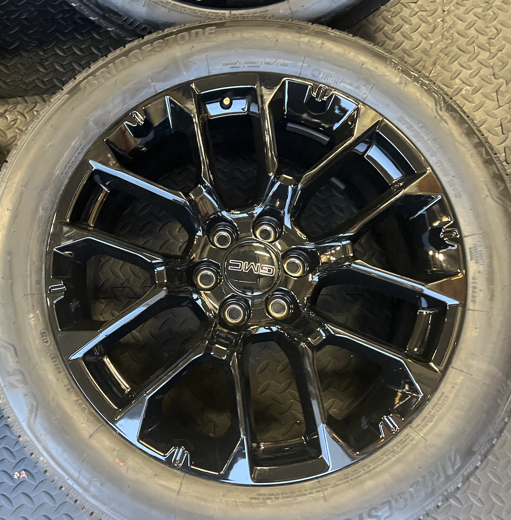 OEM 22” Gloss Black 6-Split-Spoke Replica Wheels wrapped in Bridgestone tires.