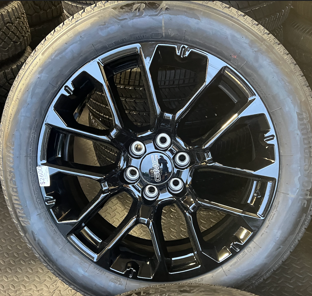 OEM 22” Gloss Black 6-Split-Spoke Replica Wheels wrapped in Bridgestone tires.