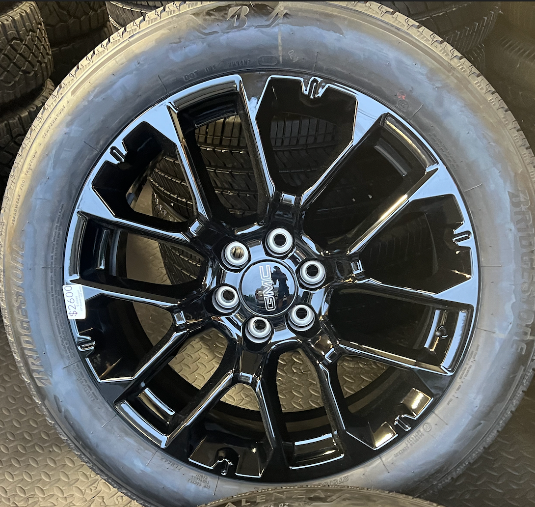 OEM 22” Gloss Black 6-Split-Spoke Replica Wheels wrapped in Bridgestone tires.