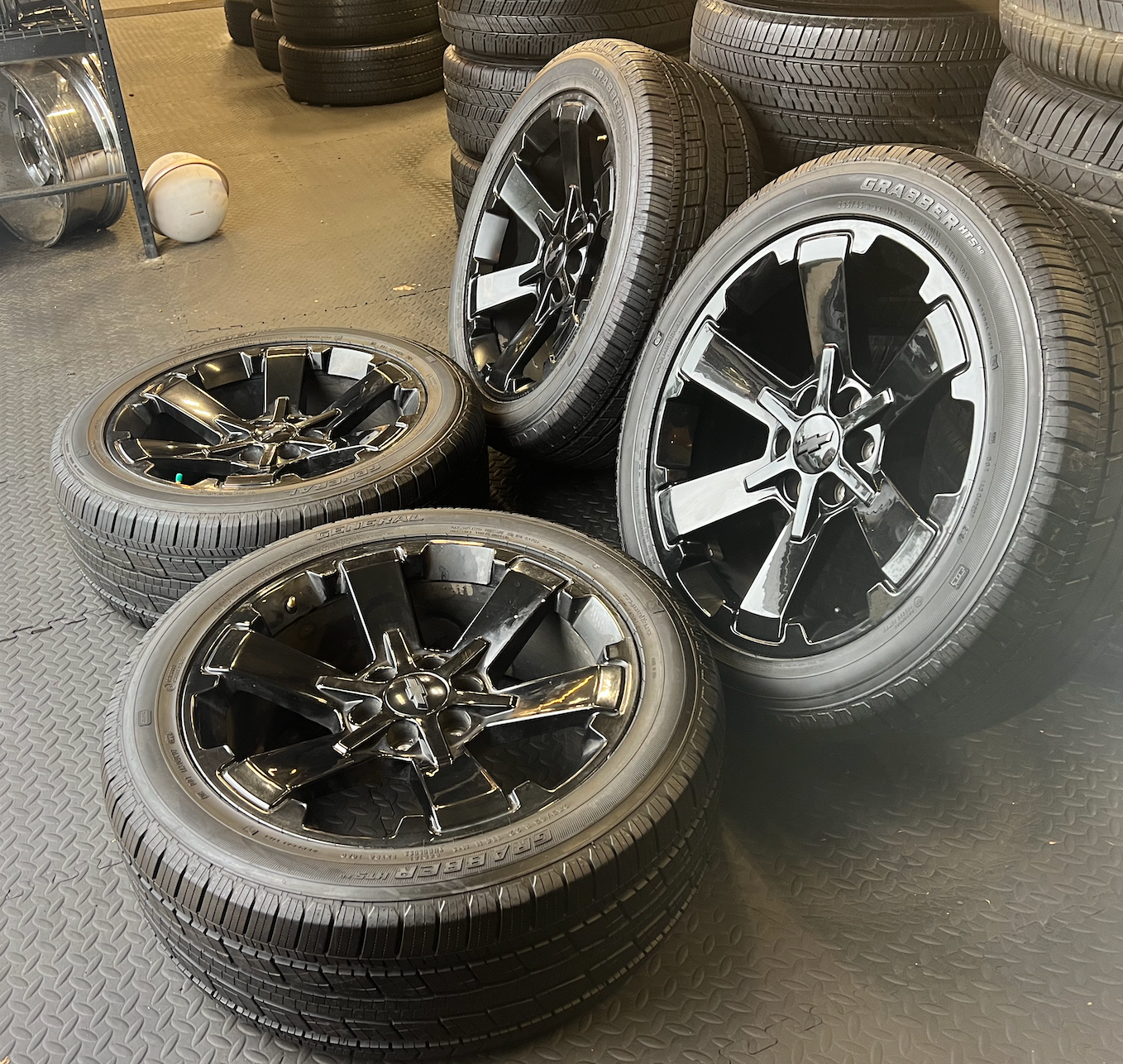 OEM 22” Gloss Black Wheels wrapped in General Grabber tires.